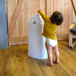 Child near diaper pail